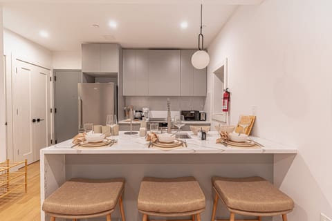 Sleek kitchen and dining area with ample counter space, perfect for dinners and brunches at home.
