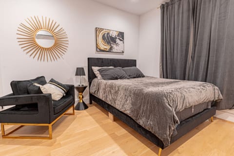 Comfortable bedroom featuring plush bed, modern nightstands and soft lighting for restful sleep