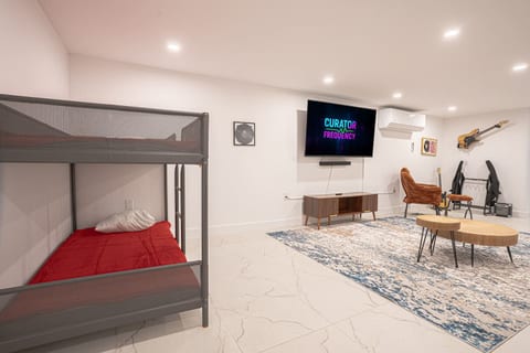Cozy basement outfitted with bunk beds, TV and music lounge area for entertainment and rest