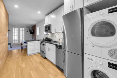 Modern kitchen with washer/dryer and seamless open layout