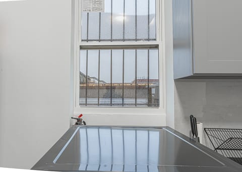 Big windows pour natural light over the kitchen counter — bright, airy, and welcoming all day.