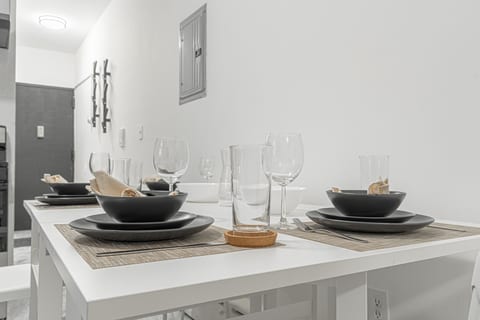 Bright dining area with seating for the group — gather for meals before hopping the 7 train into Manhattan.
