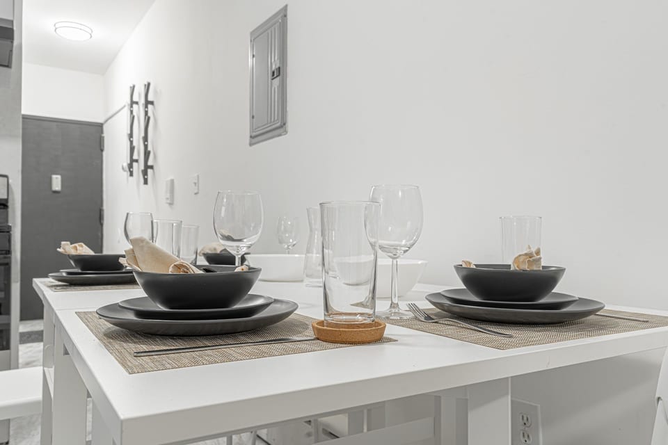 Bright dining area with seating for the group — gather for meals before hopping the 7 train into Manhattan.