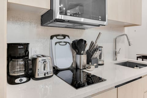 Fully equipped chef's kitchen with full-size stainless steel appliances and cookware — cook in or order from NoMad's best.