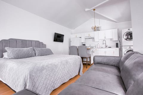 Restful queen bed with quality linens and a wall-mounted smart TV — unwind after a day exploring Los Angeles.