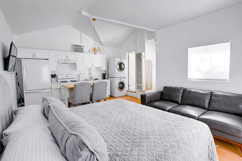 Cozy lounge area with sofa, smart TV, and the queen bed just steps away — everything you need in one stylish space.