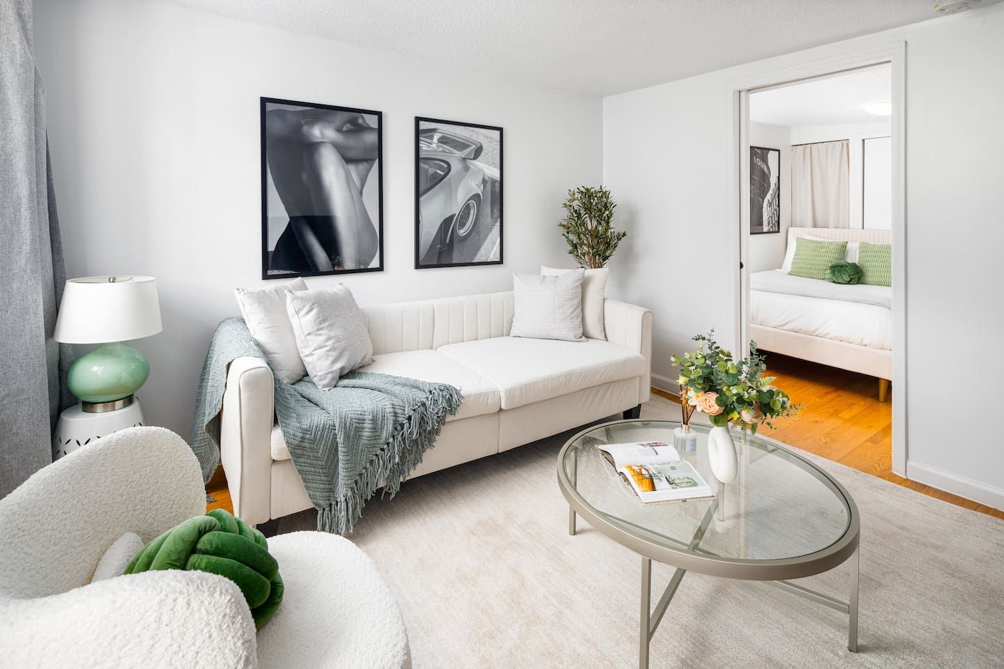 Cozy living room with stylish art, plush seating & bedroom access