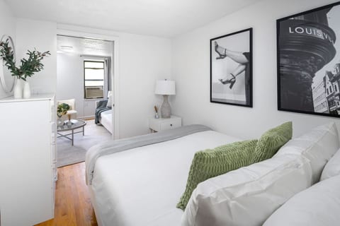 Cozy queen bedroom with chic art & seamless living room access
