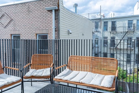 Private balcony seating for morning coffee or sunset wine in quiet Bushwick Scandinavian