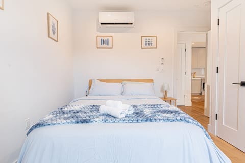 Light-up queen bed frame adds warm ambience to stylish Scandinavian Bushwick bedroom