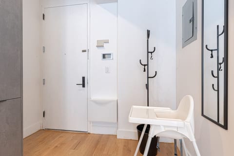 Welcoming entryway with coat hooks and a high chair — family-friendly touches greet you in this renovated Brooklyn duplex.