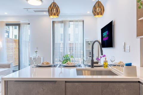 Fully renovated kitchen with a big island, modern fixtures, and bright windows — cook, gather, and dine all in one airy Brooklyn space.