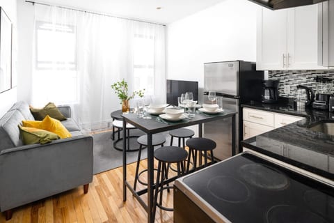 Modern kitchen, dining, and lounge space with seating for six