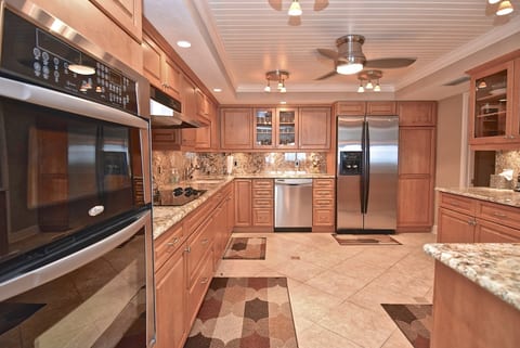Beautifully updated gourmet kitchen featuring granite countertops, stainless steel appliances, and plenty of room to prepare meals.