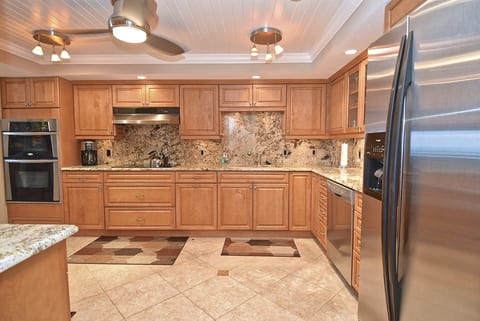 Designed with extended stays in mind, this spacious kitchen offers abundant cabinetry and generous workspace.