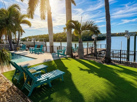 Waterfront yard with dock for fishing and launching paddle boards and kayaks and turf for chilling