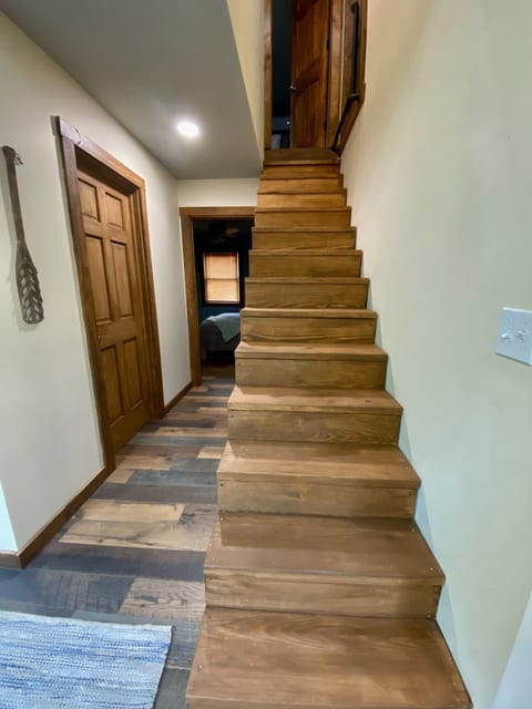 Rustic wood staircase and cozy hallway with warm cabin-style charm
