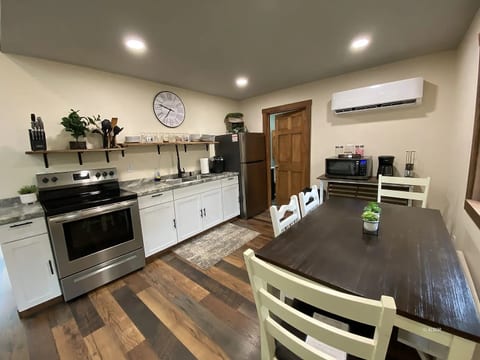 Bright kitchen with dining table, stainless appliances, and cozy modern style