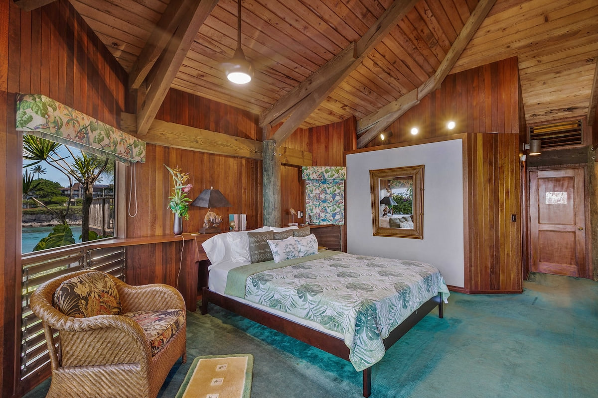 Cal king bed, lounging chair, and lots of storage in the master bedroom.