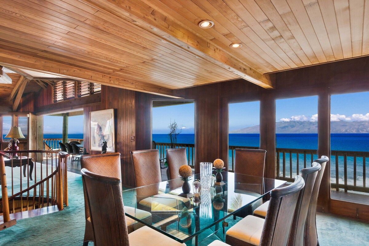 Elegant interior dining room with a wet bar and direct access to the kitchen.