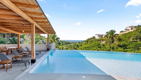 Perched above Sayulita’s vibrant North End, our spectacular rooftop is a destination all its own. Take in sweeping ocean views while relaxing in the sparkling infinity-style pool, fire up the barbecue grill for an unforgettable sunset dinner, or unwind in the expansive green lawn perfect for yoga, stretching, or simply soaking up the tropical sunshine.