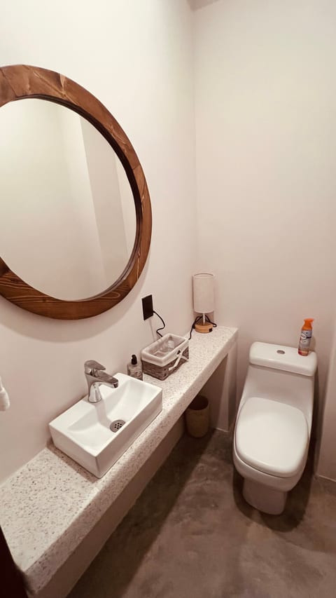 Conveniently located just off the kitchen and main living area, the half bathroom provides added comfort and functionality for guests. Featuring a modern vanity with sink and a toilet, it’s perfect for freshening up without needing to access the private en-suite bathrooms.