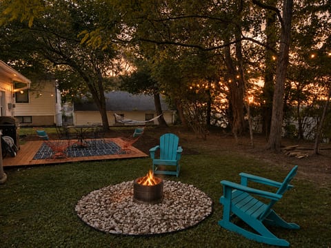 Enjoy the outdoor fire pit with rocking Adirondack chairs, outdoor dinner table, and hammock
