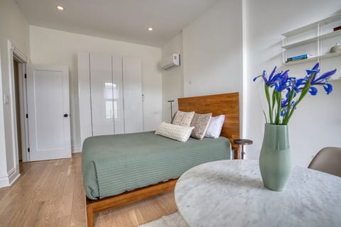 Queen sized bed on the main floor of duplex complete with en-suite bathroom with heating floors for additional comfort.