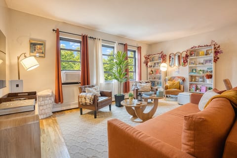 Vivid living room with arm chair reading space. Sofa also offers a pull up queen sleeper.