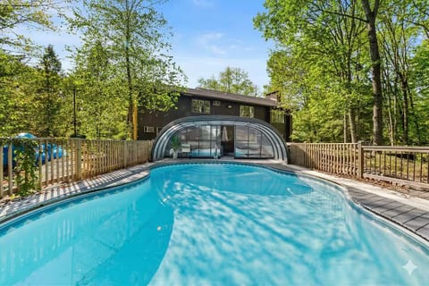 Heated indoor-outdoor pool with retractable enclosure — enjoy a swim year-round!