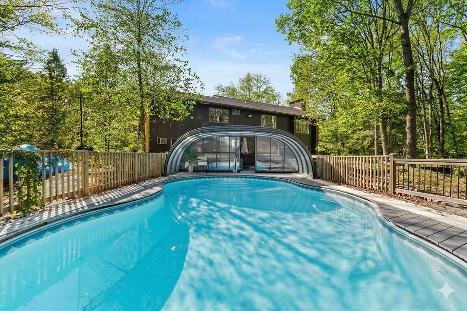 Heated indoor-outdoor pool with retractable enclosure — enjoy a swim year-round!