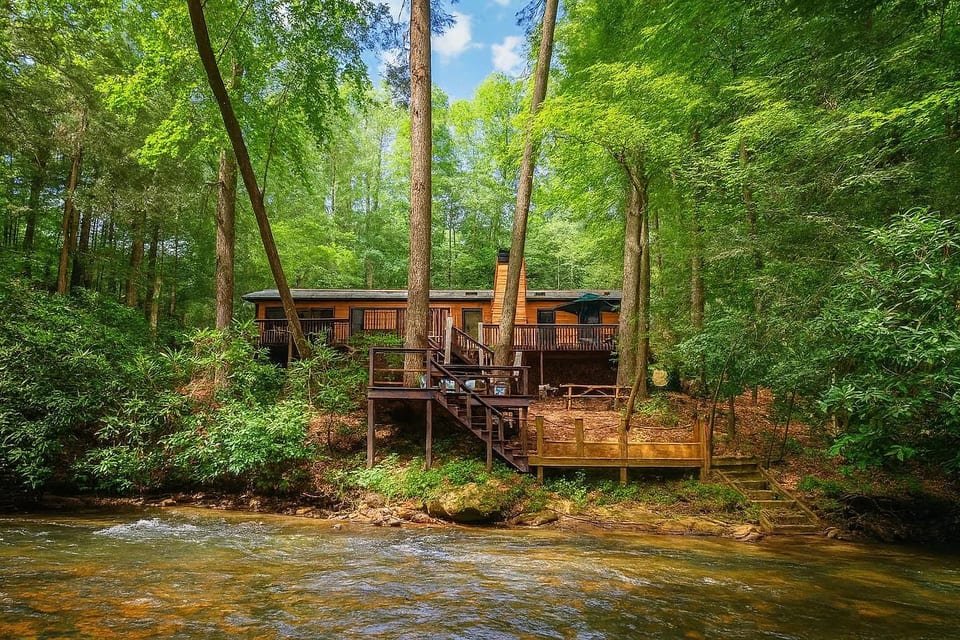Riverfront, single-story cabin with 3 decks, including a dock & water access. Soak in the hot tub, play in Fightingtown Creek, cook dinner on the grill, roast s'mores over the fire pit. Dog friendly. 3 Masters with attached full bathrooms!