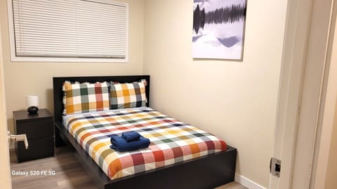 Bedroom on the main floor with a double bed and a bedside chest