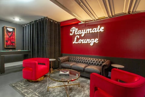 Main lounge area with custom neon lighting, leather seating, and premium entertaining space.