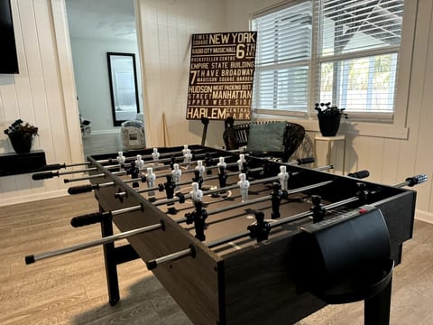 A welcoming entertainment area centered around a foosball table, encouraging fun, teamwork, and memorable moments.