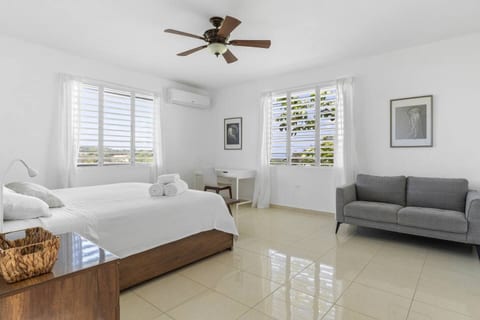 A bright, airy master suite with AC and peaceful hillside views designed to ensure restful nights after long days of sun, surf, and adventure.