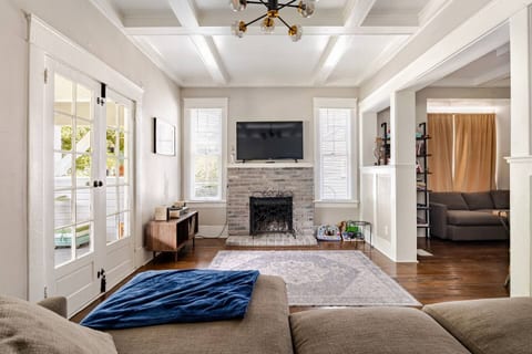 Inviting living room with a classic fireplace, stylish décor, and warm natural light. A comfortable spot to relax, read, or enjoy a calm evening at home.