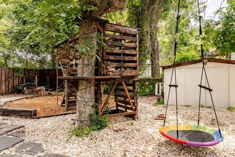 Family friendly backyard with a fun tree fort and plenty of room to play. Kids love this space, and it is a great area for enjoying fresh air under the shade of mature trees.