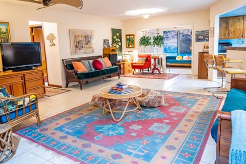 Spacious open living area with vibrant rugs, vintage pieces, and comfy seating. Ideal for families, creatives, or anyone who loves a colorful, personality-filled space to unwind and feel at home.