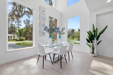 Flooded with natural light, this open concept living and dining space is perfect for relaxing, sharing meals, and enjoying the clean modern coastal vibe.