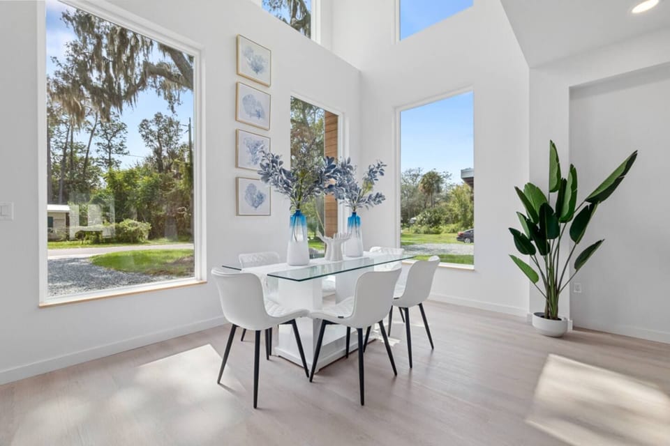 Flooded with natural light, this open concept living and dining space is perfect for relaxing, sharing meals, and enjoying the clean modern coastal vibe.