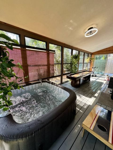 Relax in the screened patio with a private hot tub and leafy canal views, the perfect spot to soak, unwind, and enjoy quiet Florida evenings in any season.