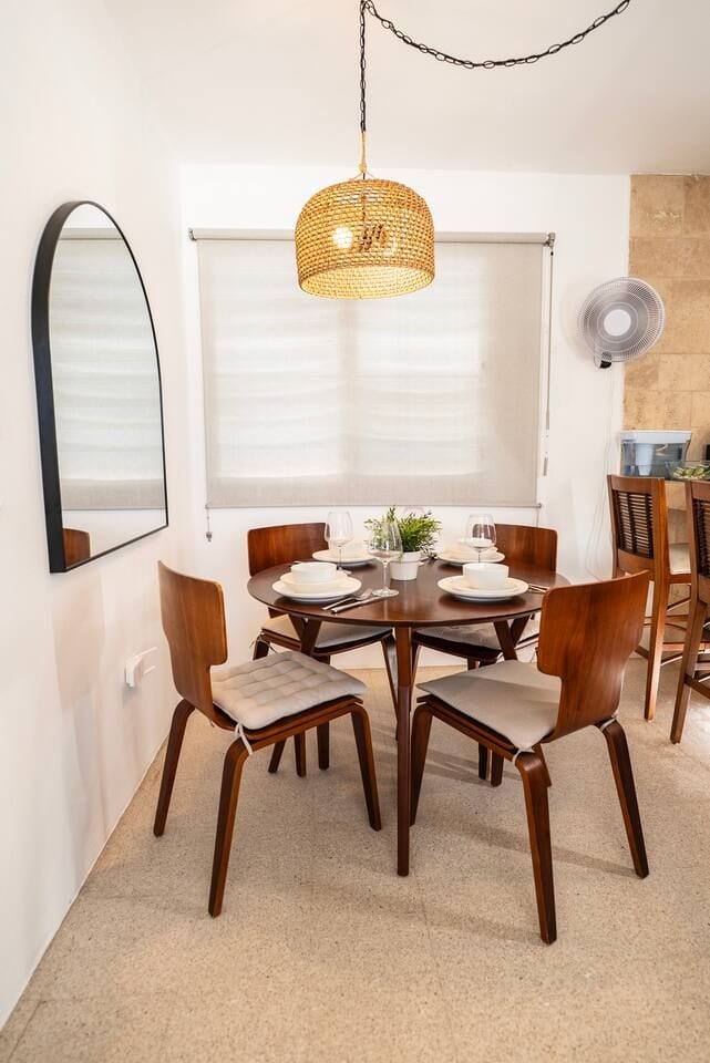 Cozy dining nook with warm lighting, modern wooden chairs, and a welcoming table set for shared meals.