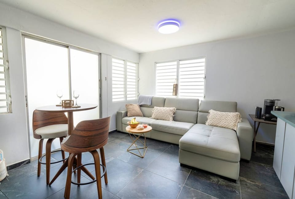 A sun-filled living room with a modern sofa, sleek seating, and an easygoing, coastal feel.