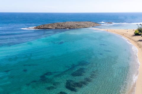 A stunning coastal setting with crystal-blue waters and golden sand just minutes from the property perfect for relaxing beach days.
