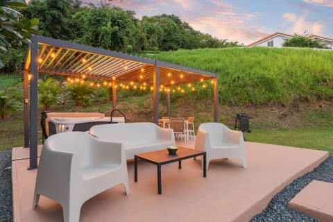 Cozy pergola lounge with warm lights, perfect for relaxing outdoors
