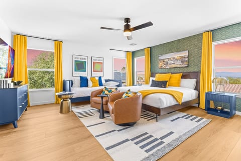 This is the large primary bedroom. It inlcudes a king bed, a twin-sized day bed, swivel chairs, a workdesk, and a 65" 4K TV. This room has a dedicated bathroom with a tub/shower combo. Has a view of the Las Vegas Strip! -Adventure Awaits