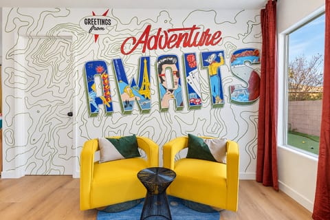 Two yellow swivel chairs sit right under the mural with a small side table between them. Grab a seat and catch up over coffee.