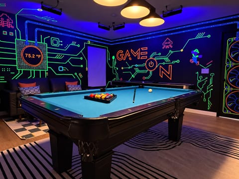 Rack the balls and break on the pool table under the glowing black light walls. When you need a break, try air hockey, shuffleboard, the 3 arcade games with thousands of games, or the 85" 4K TV.