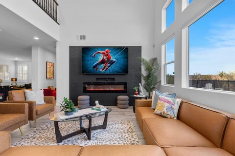 Main Living Room with vaulted ceiling, electric fireplace, and a 85" 4K TV. A fantastic gathering place for your group. -It's Showtime!